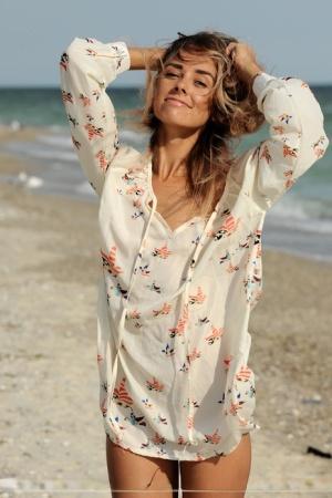 Thin teen girl Dara M wears only a smile while romping on a sandy beach