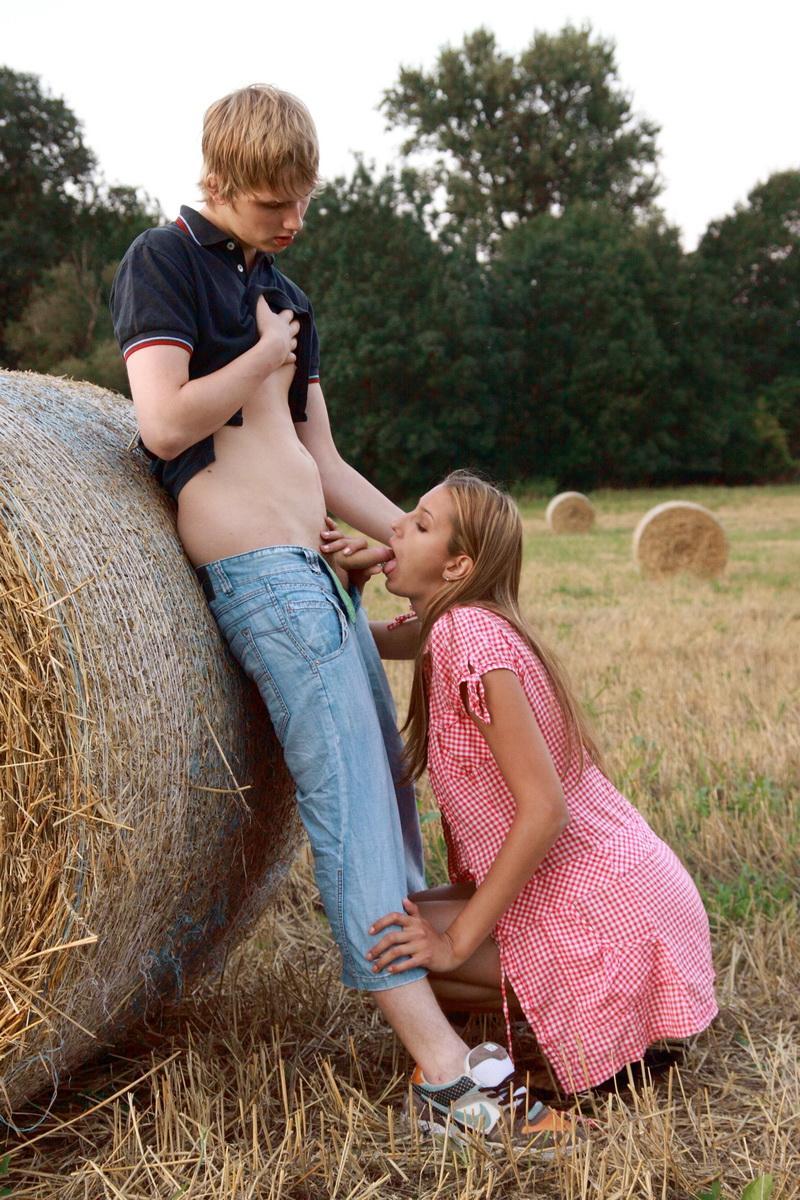 Horny young couple have sexual intercourse against a round bale in a field(5)