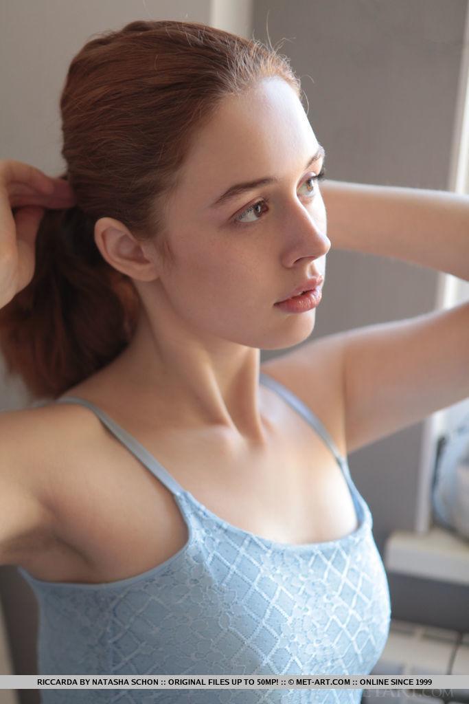 Young redhead Riccarda works free of a dress to pose naked in the kitchen(1)