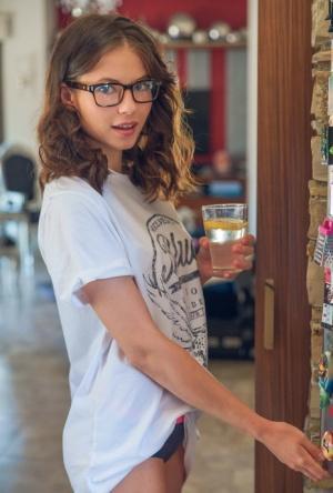 Teen with glasses Hilary gets nude in the kitchen to enjoy her lemon water