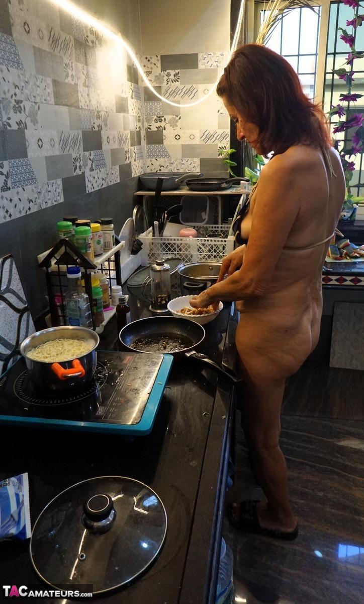 Mature lady Diana Ananta cooks up a meal while wearing a bikini(6)