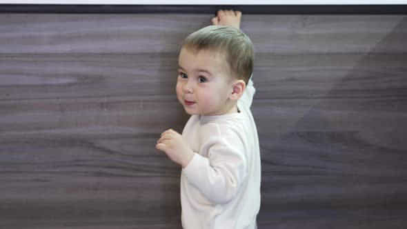 Angelic Toddler In White Sweatshirt Stands At The Kitchen Buffet - VideoHive 49923613