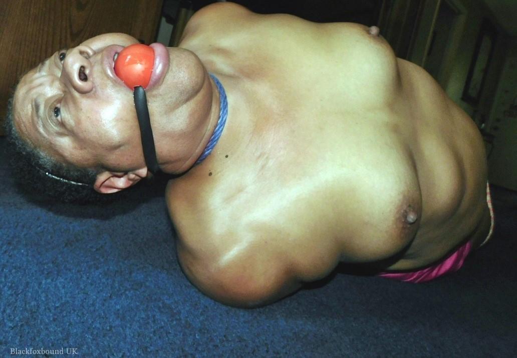 Overweight black woman Trixie struggles against a ball gag while hogtied(12)