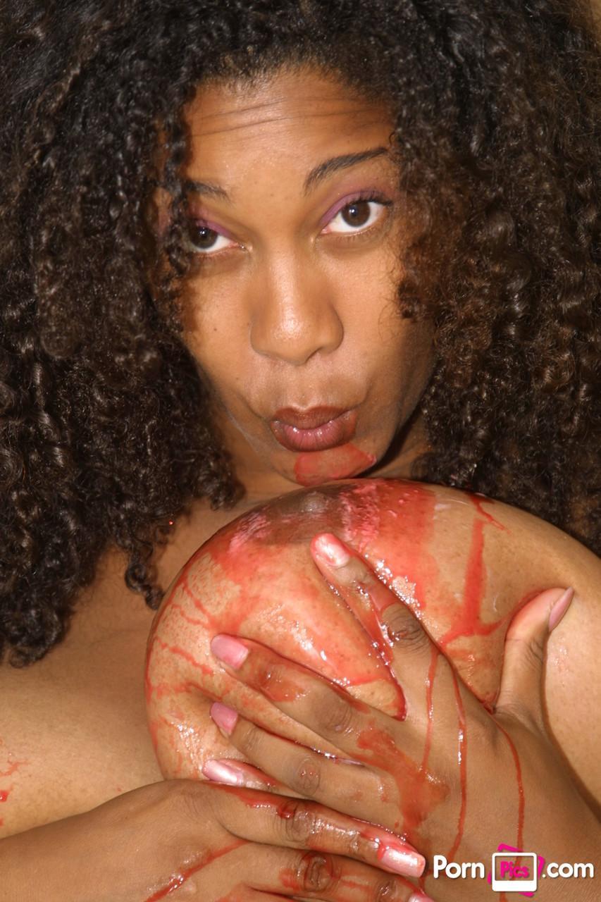 Curly haired ebony Chaka Titties plays with her huge juggs and gets them messy(12)