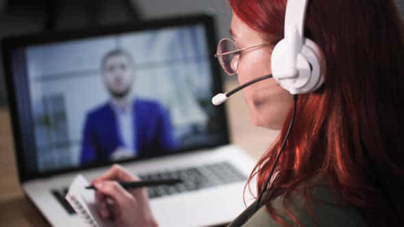 Online Conference Young Woman With Headphones And A Microphone Talks To A Man Via Video Conference - VideoHive 52493207