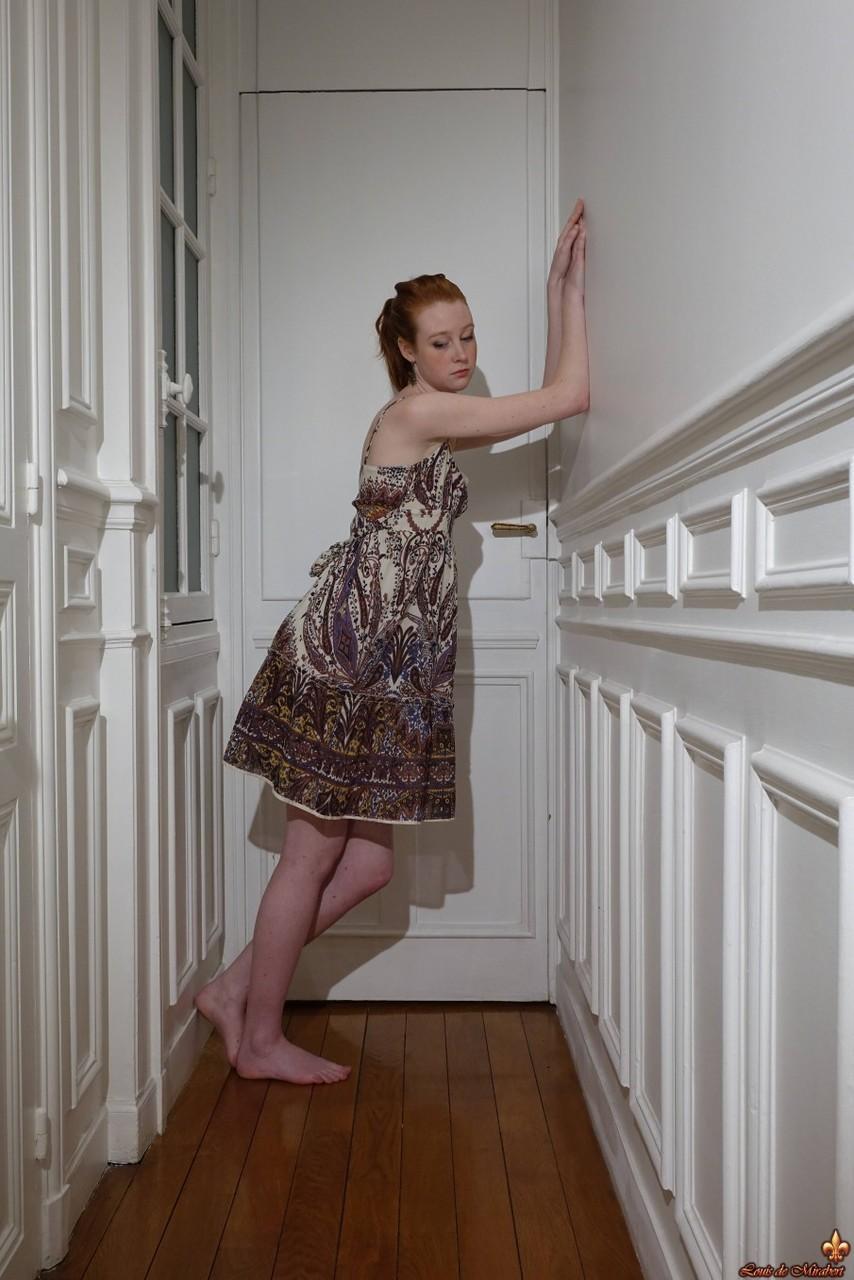 Pale redhead Nathalie Lawson exposes her upskirt underwear in a hallway(6)