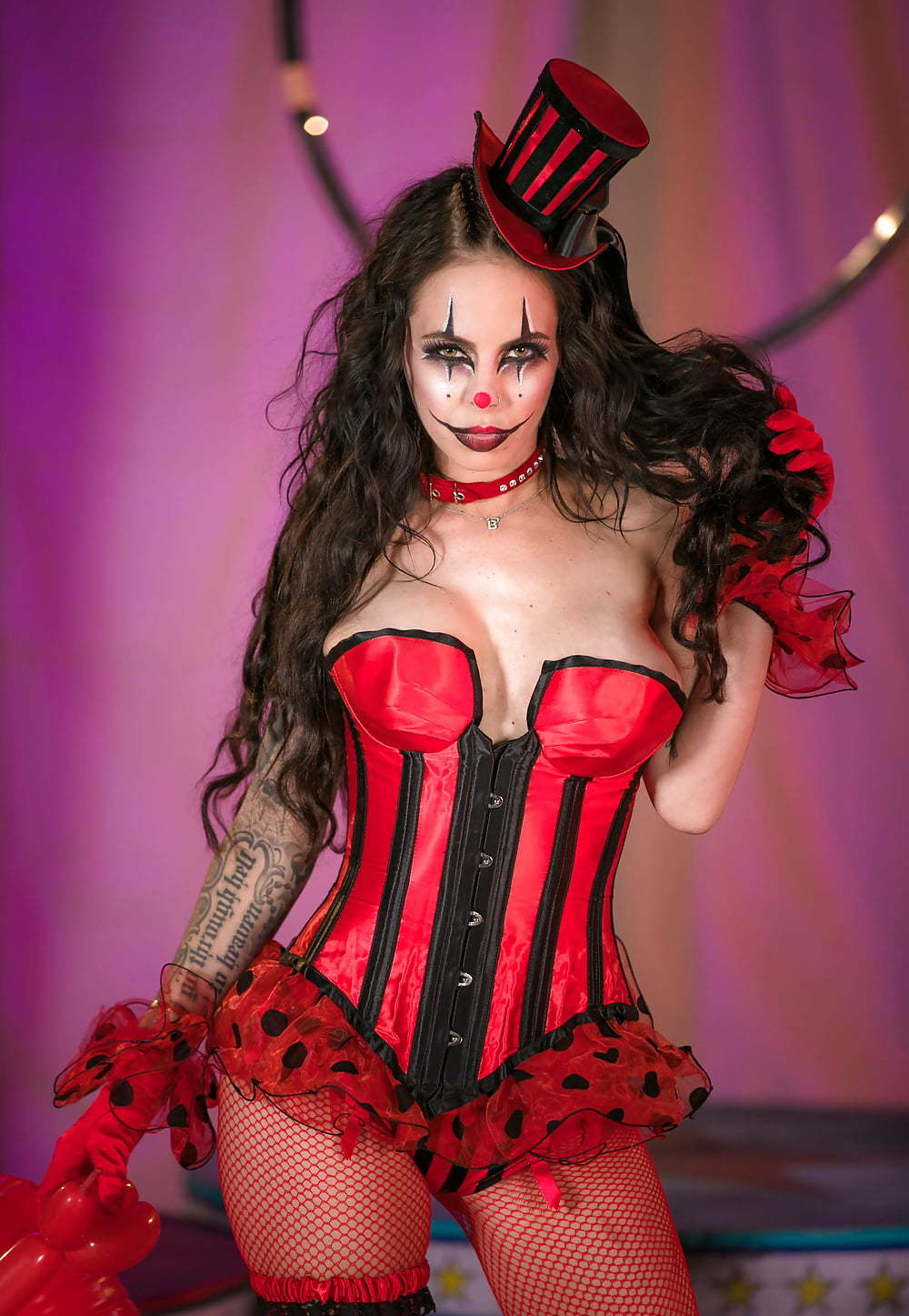 Woman in erotic clown outfit poses