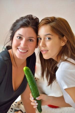 Barely legal lesbians with perky tits insert cucumbers into horny cunts