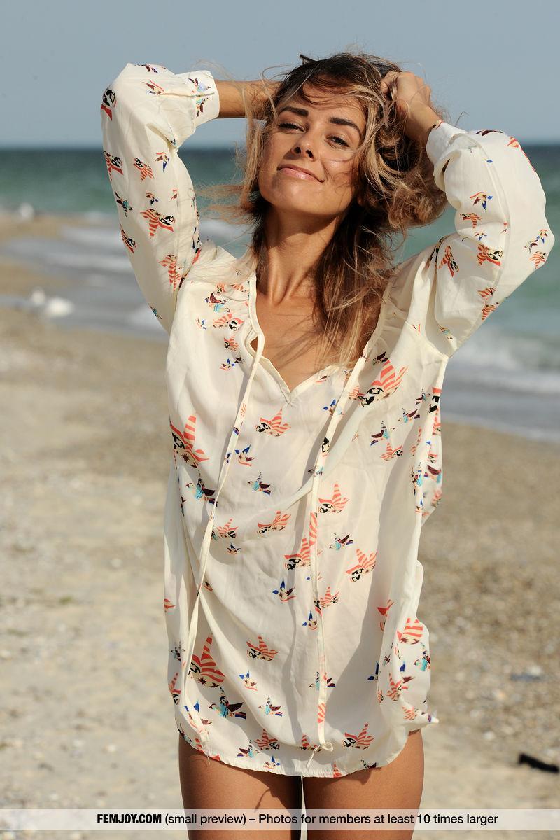 Thin teen girl Dara M wears only a smile while romping on a sandy beach(1)