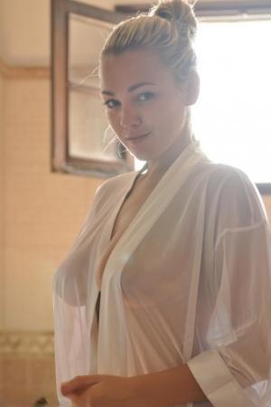 Beautiful blonde chick Jodie Gasson pulls on a see thru blouse in the morning