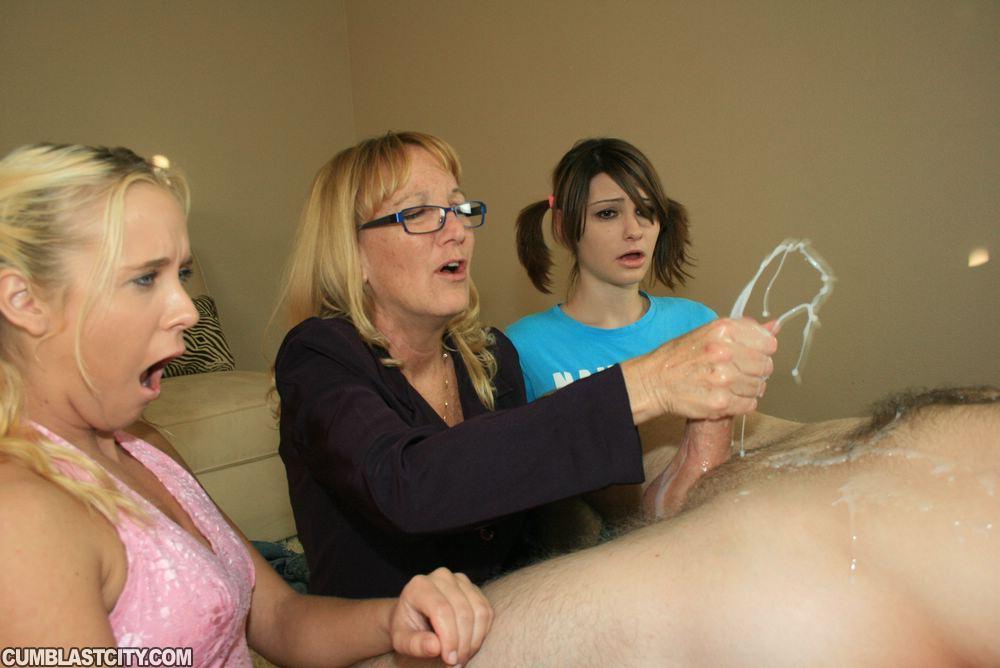 Mature blonde in glasses teaching her teen friends how to stroke a big cock(10)