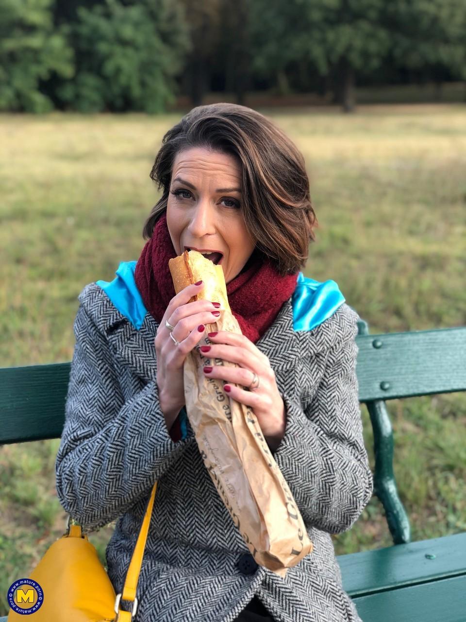 French mom Anya flashes her legs in stockings while eating a sandwich outside(17)