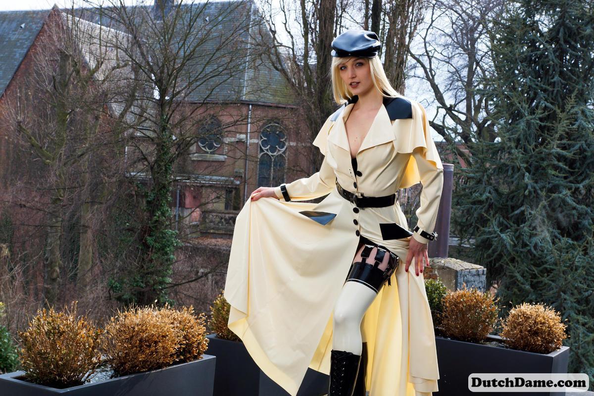 Hot blonde flashes latex garters while modeling outdoors in rubber attire(11)