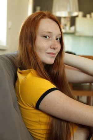 Long-haired redhead Petrine Krahlove shows her big ass & her natural tits