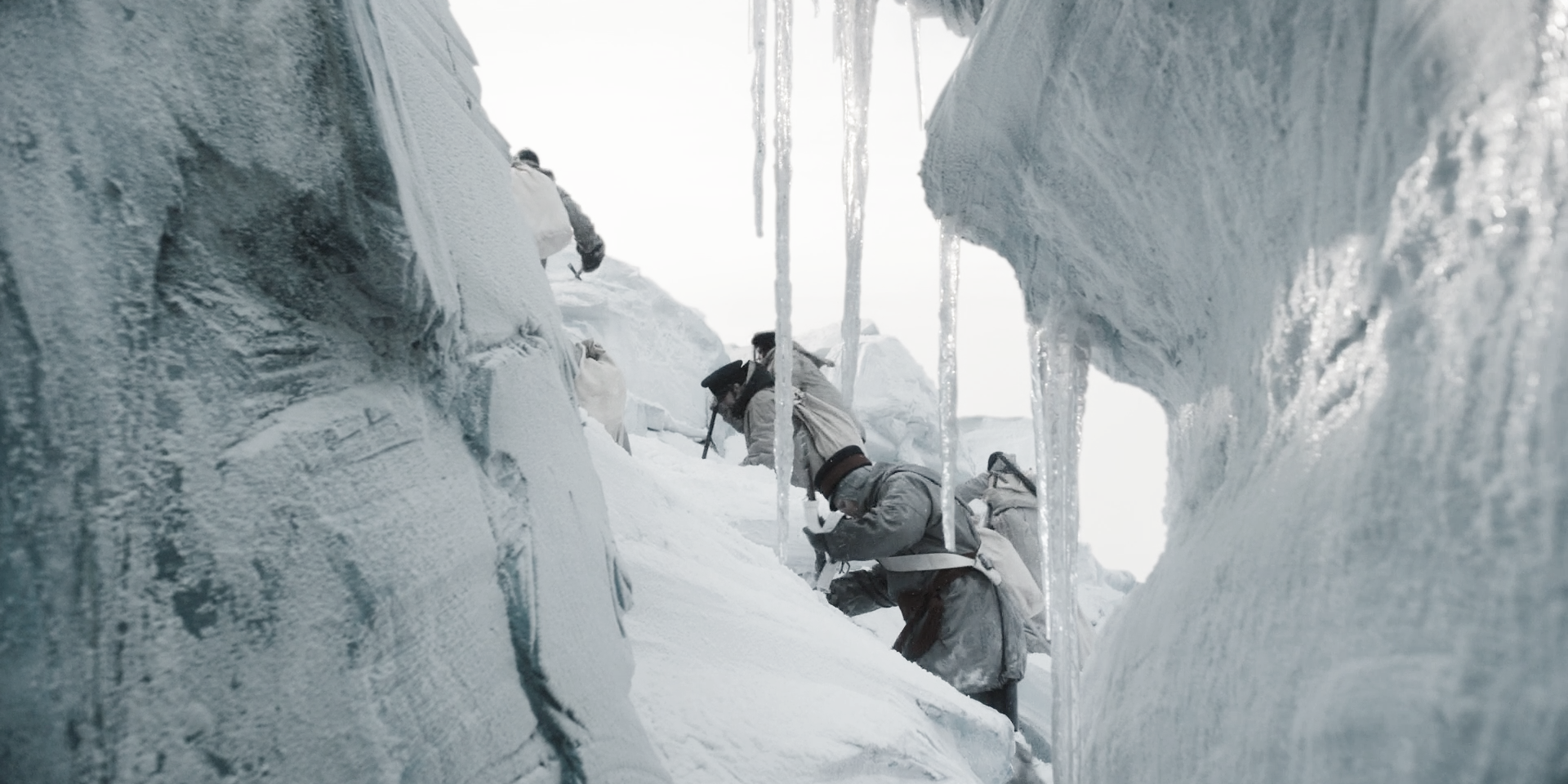 People climbing up the side of a wall of ice