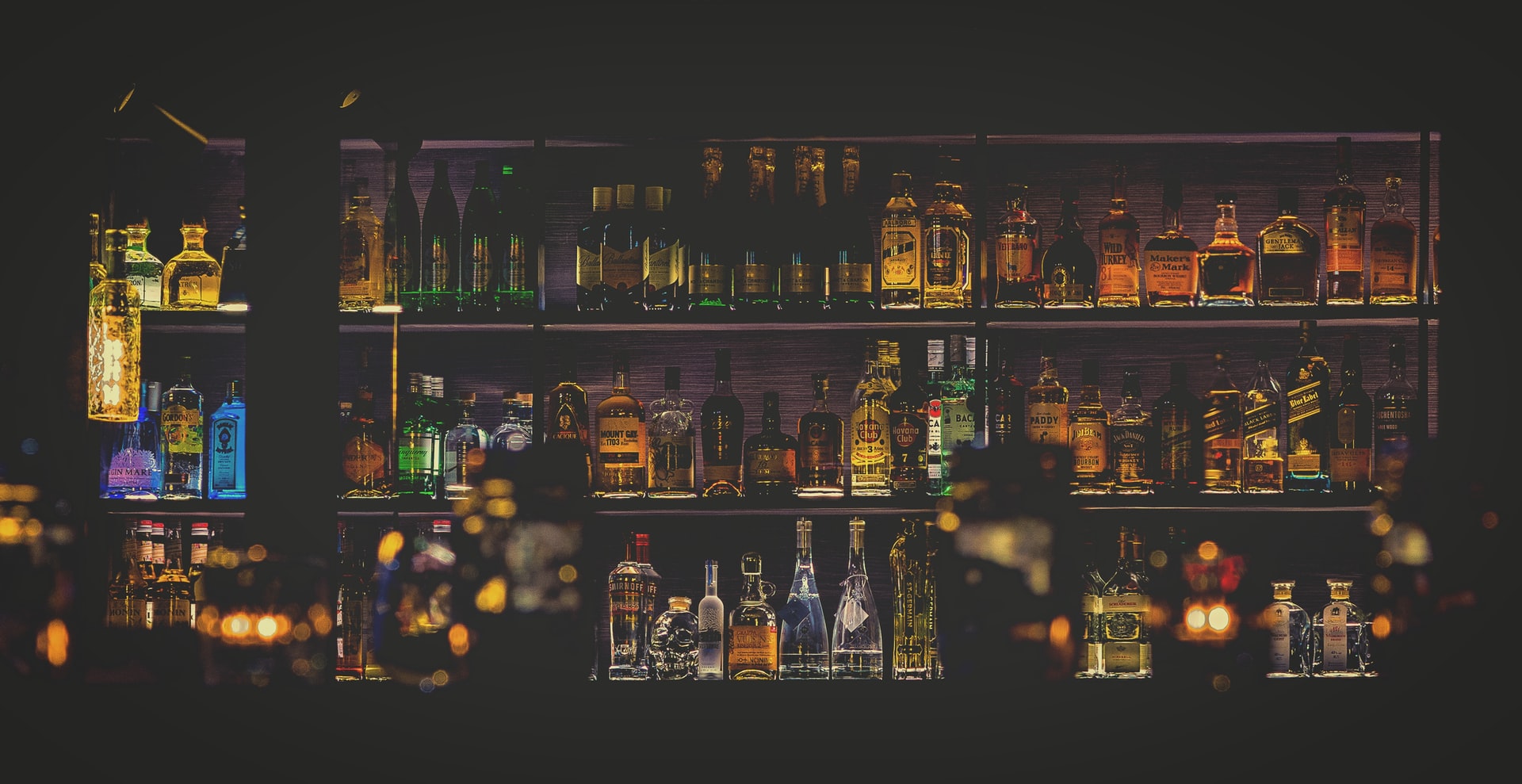 Shelves of bottles behind bar