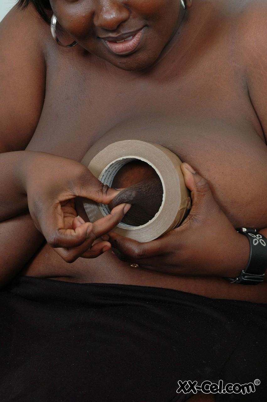 Afro-American BBW Mariana Kodjo wraps her huge tits in duct tape & poses nude(13)