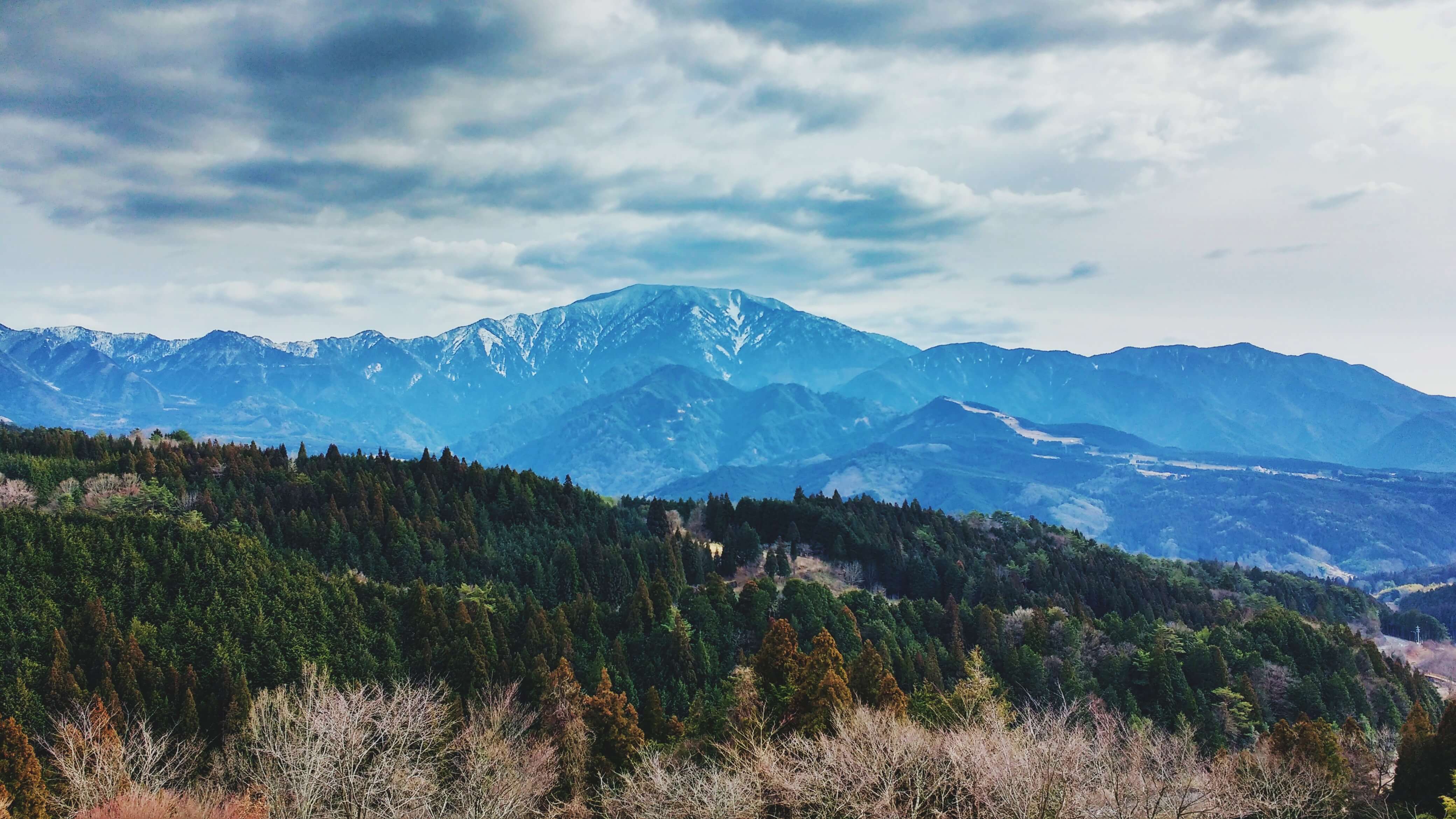 A hill with blue mountains behind