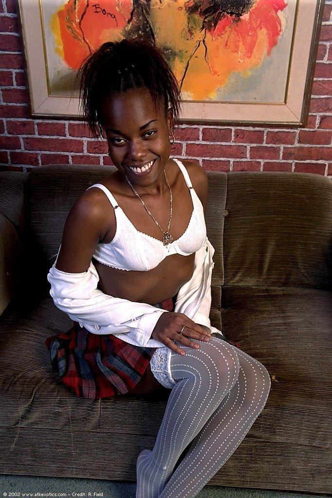 Ebony schoolgirl Jezebel	toys herself as she strips to her white stockings(5)