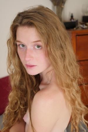 Pale redhead Karina Pontiac slips off her robe to model totally naked on bed