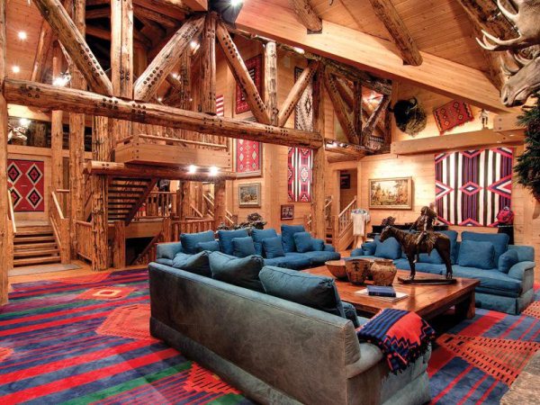 Sofas arranged in lounge of large log cabin