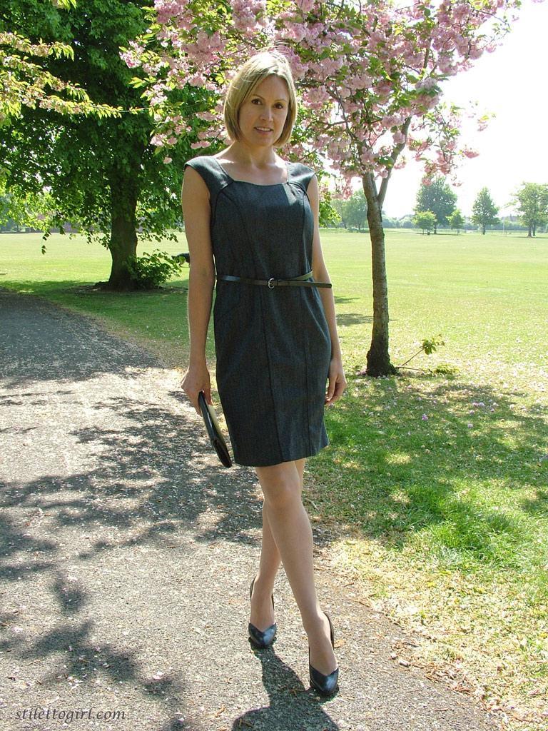 Clothed business woman shows off her sexy legs in high heels in the park(11)