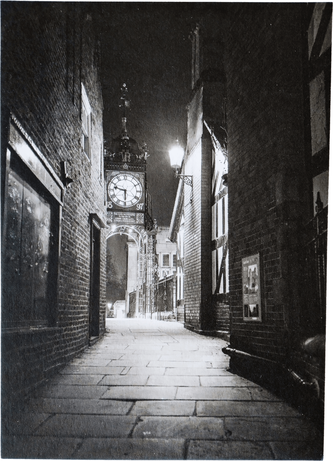 A an old city street at night and a clock