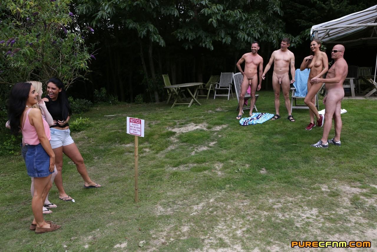 Lovely clothed female students blow off a nudist colony outdoors(4)