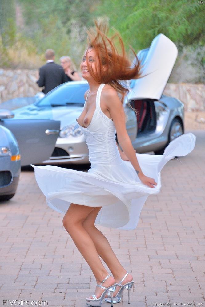 Sexy redhead with big hard nipples flashes naked upskirt in the driveway(11)