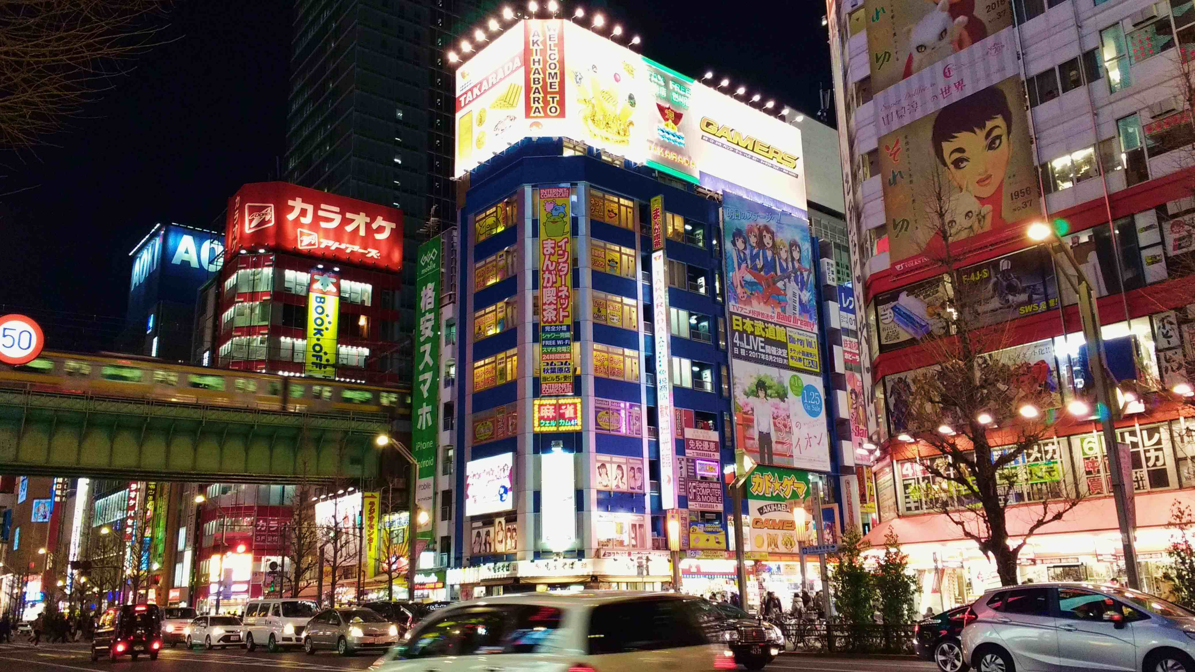 A brightly lit inner city street at night