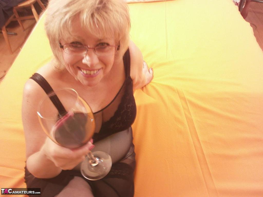 Tipsy hot granny Caro spreading legs on the bed wearing black stockings(4)