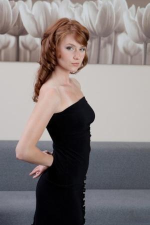 Natural redhead Nomi pulls down and hikes up her black dress to show her wares