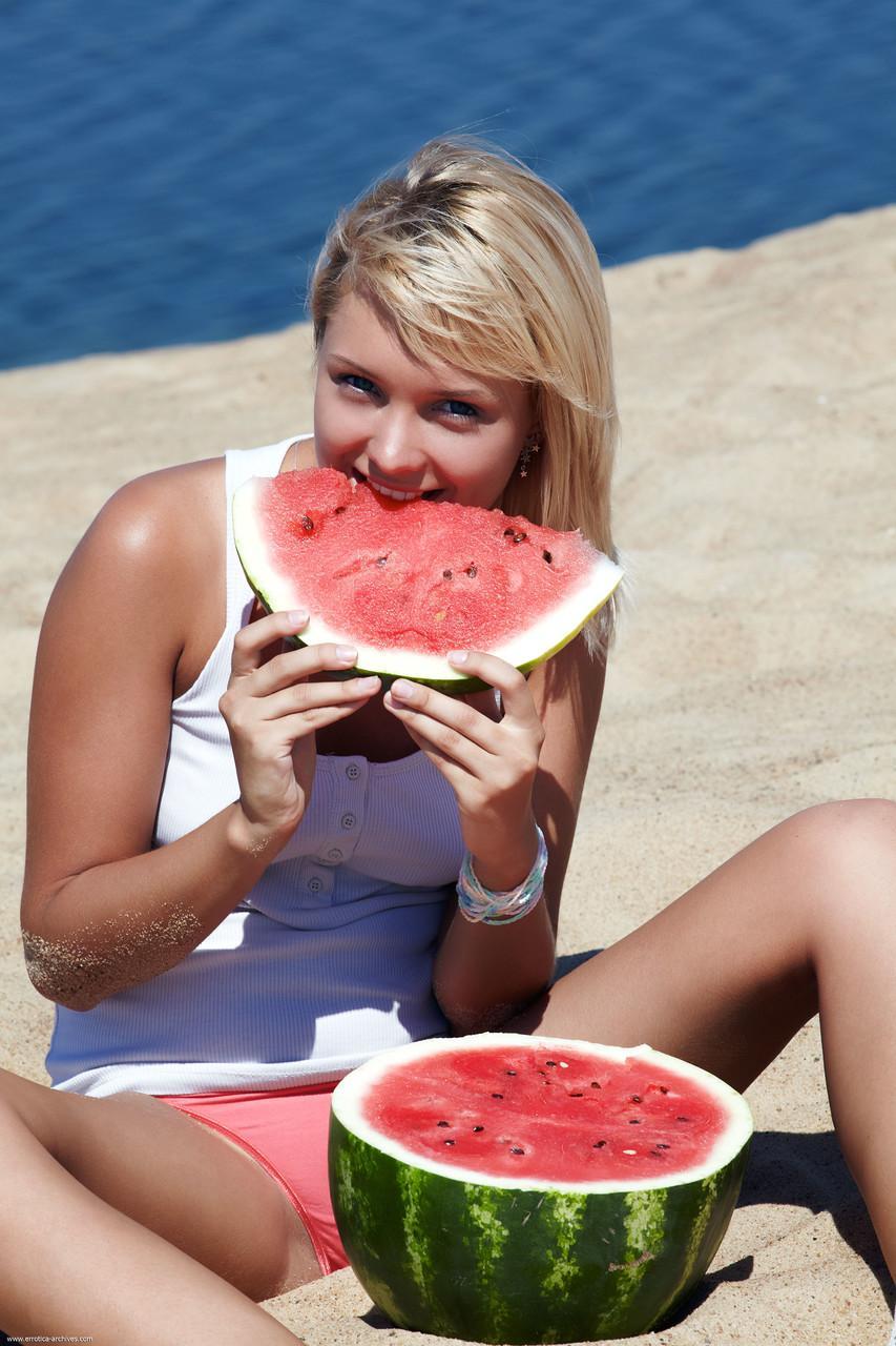 Adorable blonde Lada displays her beautiful shaved pussy on a sandy beach(1)