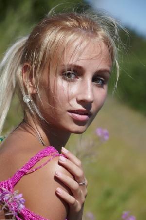 Slim blonde teen Afina flaunts her tasty pussy and shiny body outdoors