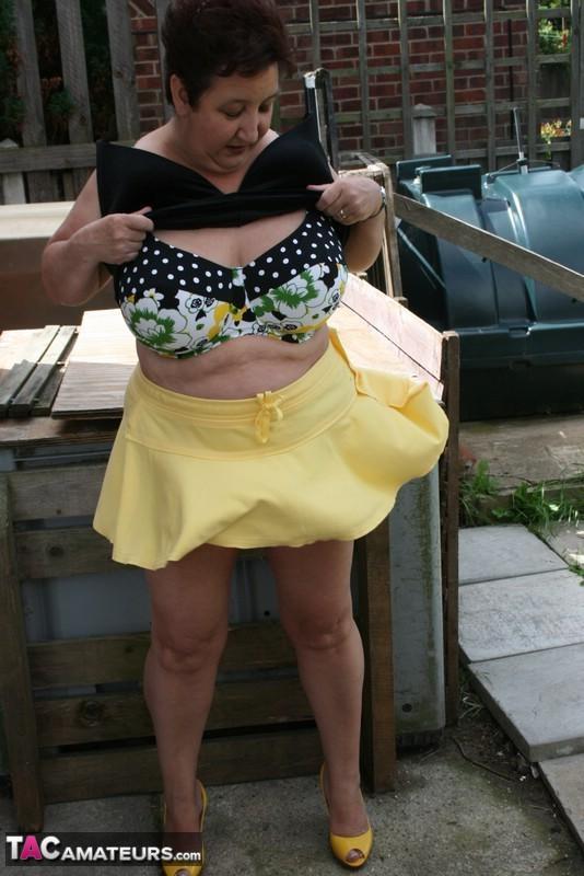 Fat older woman Kinky Carol flashes her bra and upskirt underwear on a patio(15)