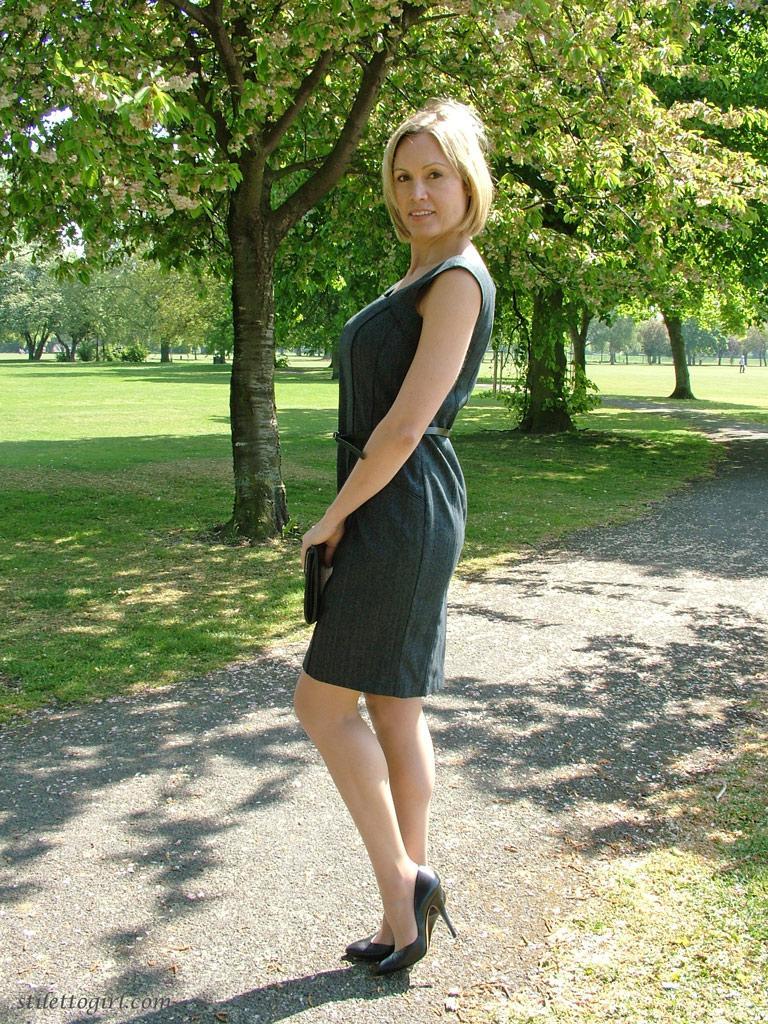 Clothed business woman shows off her sexy legs in high heels in the park(12)