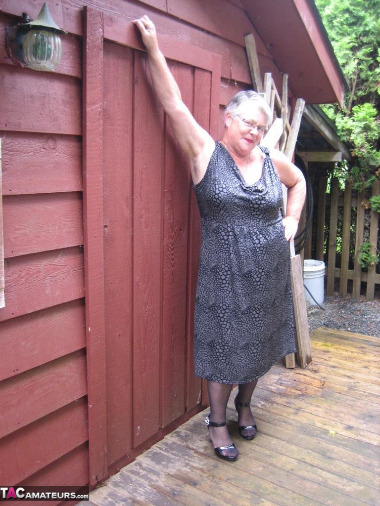 Fat oma Girdle Goddess unleashes her large boobs next to a boarded-up building(3)