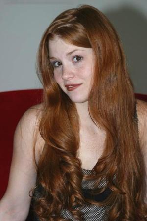 Fair skinned redhead Tiffany shows the pink of her teen pussy up close