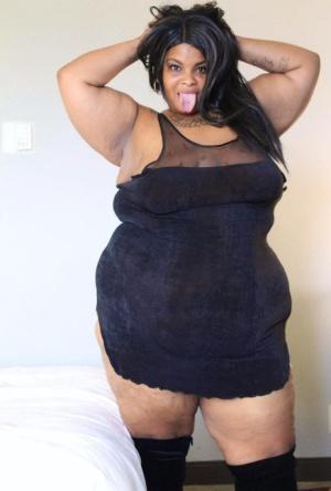 Ebony SSBBW Carmel Squirtz releases her massive ass from a black dress