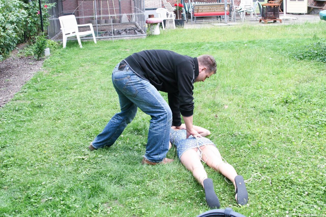 Young girl Veronika caught, hogtied, gagged, and left lying on the grass(14)