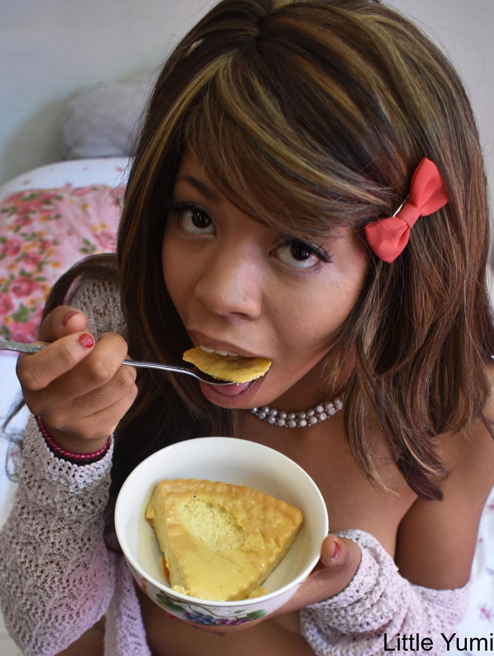 Black babe in gray socks Little Yumi flaunts her tits while eating on a bed(10)