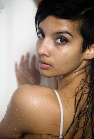 Indian solo girl takes off her wet dress to pose nude in the bathtub