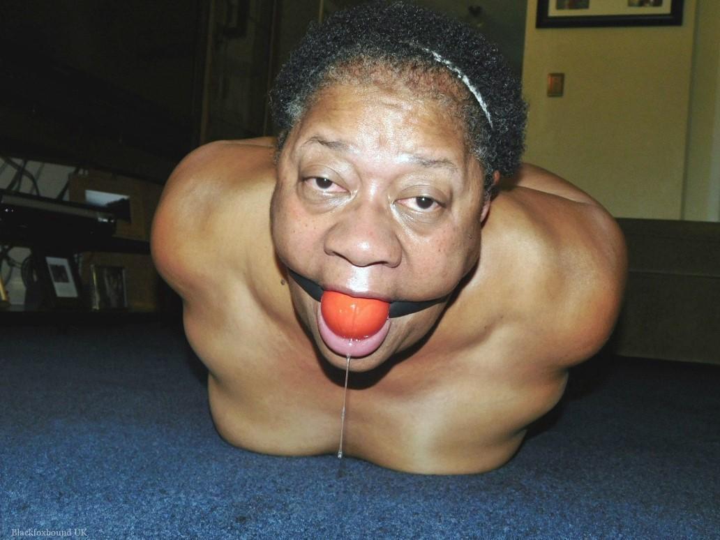 Overweight black woman Trixie struggles against a ball gag while hogtied(4)