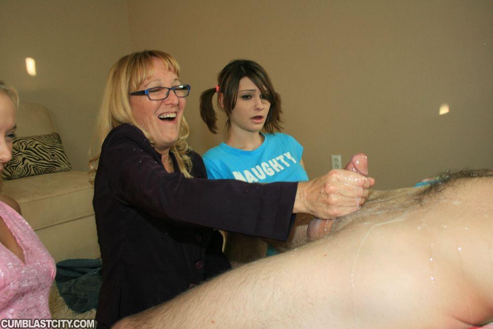 Mature blonde in glasses teaching her teen friends how to stroke a big cock(14)